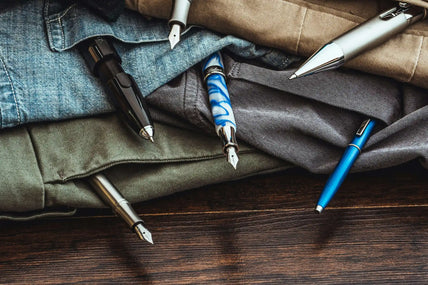Assorted pens in clothing pockets.