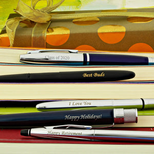 Engraved pens on books.