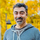 Smiling man with graying hair.