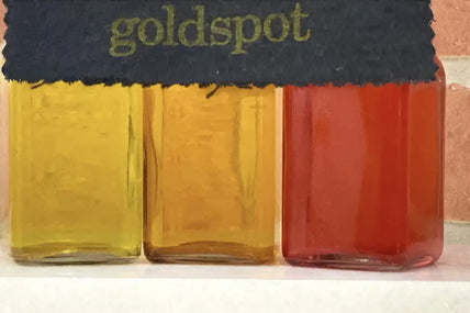 Three jars of colorful liquid.