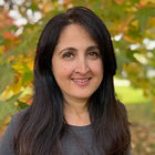 Smiling woman with dark hair.