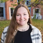 Smiling woman with long hair.