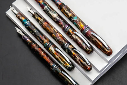 Iridescent resin fountain pen with gold accents and a sleek, modern design.