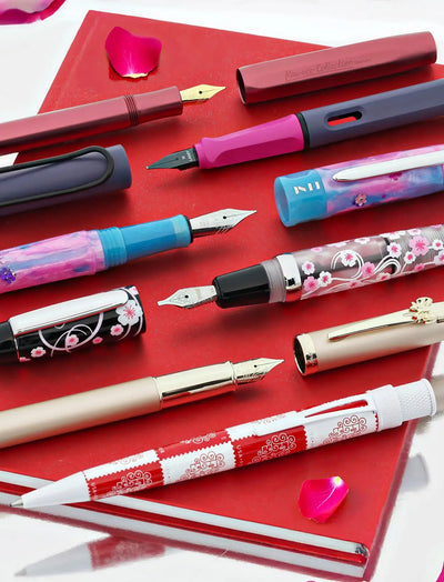 A red and white patterned fountain pen with a decorative swirl design.