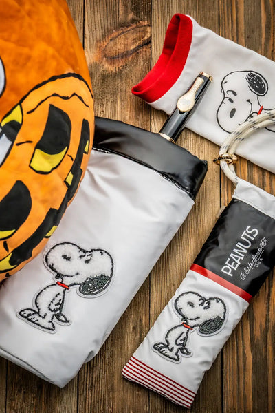 Snoopy-themed halloween treat bag with a white and black design featuring the peanuts character.